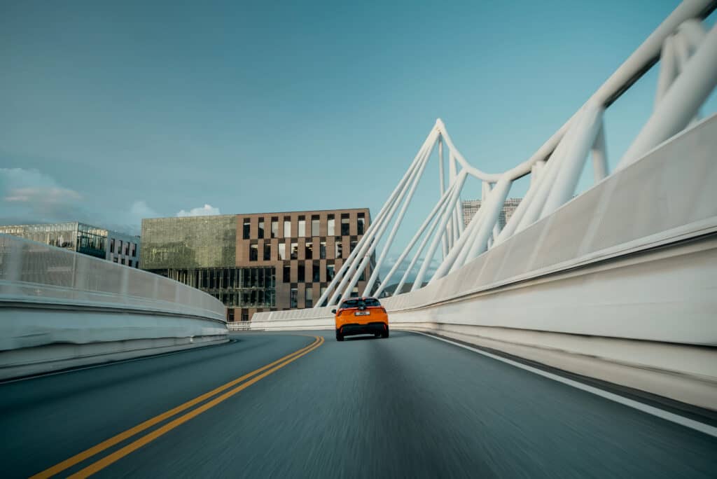 MG4 driving on a bridge in a city